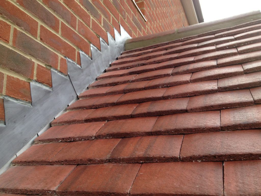 Freshly dressed lead flashing around a chimney by HomeShield