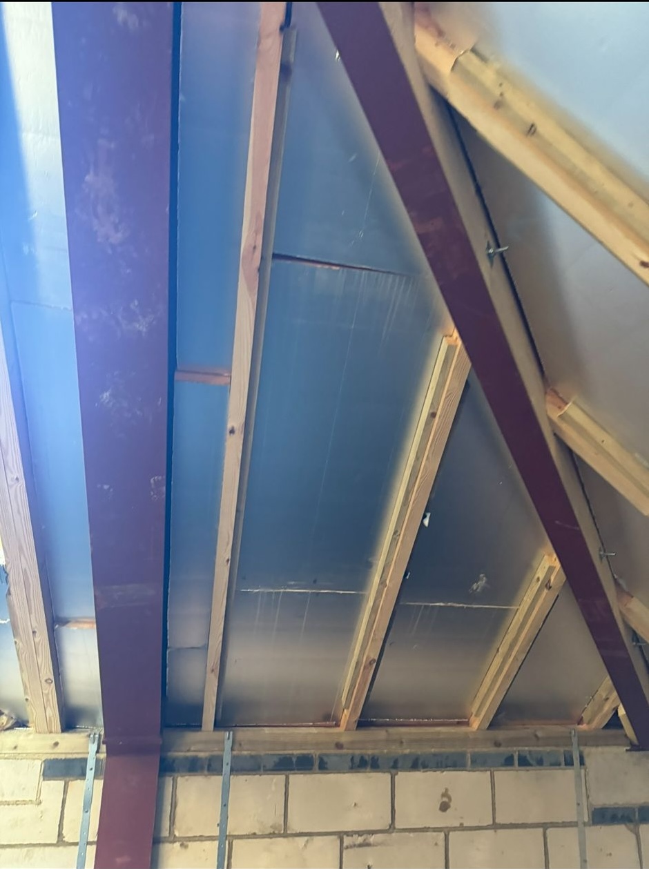 Freshly installed loft insulation to reduce heat loss in a Dorset home